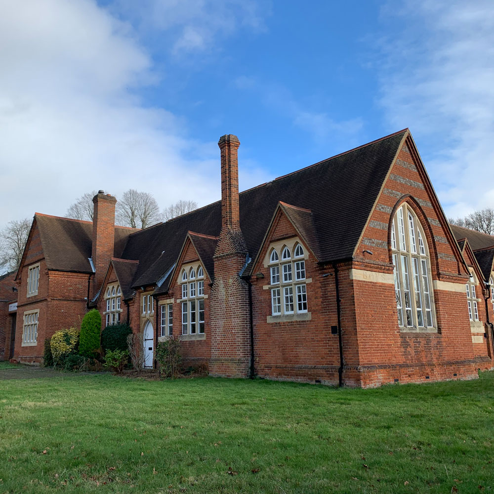 The First School on School Lane, a brick building with arched windows